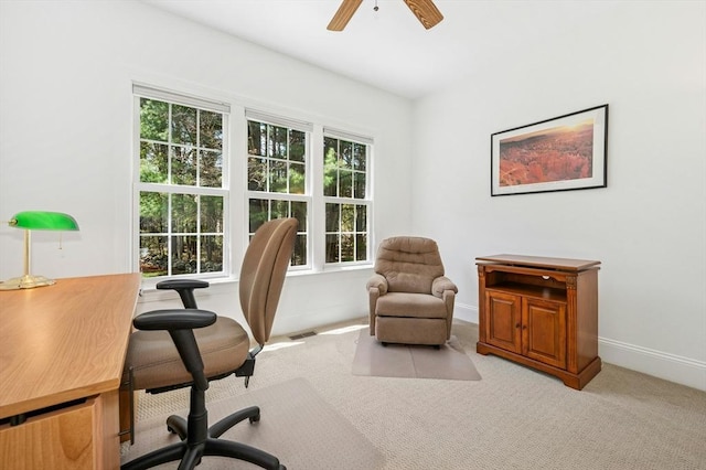 carpeted office featuring baseboards, ceiling fan, and visible vents
