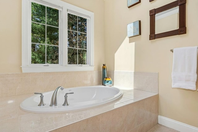 full bath with baseboards, a wealth of natural light, and a garden tub