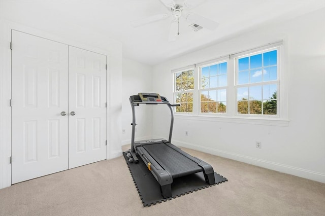 exercise area with carpet floors, baseboards, ceiling fan, and visible vents
