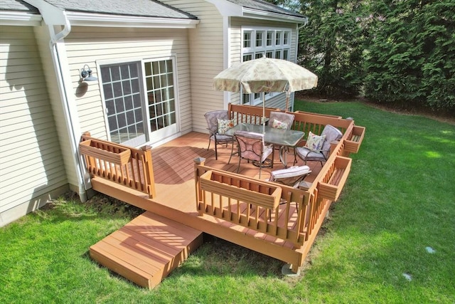 wooden terrace with a yard and outdoor dining space