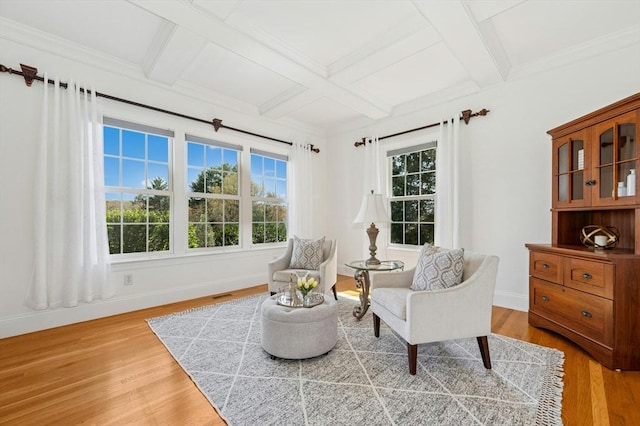sitting room with beam ceiling, light wood finished floors, baseboards, visible vents, and coffered ceiling