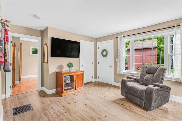 foyer entrance with baseboards and light wood finished floors