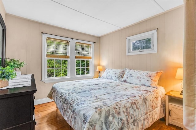 bedroom with wood finished floors and baseboards