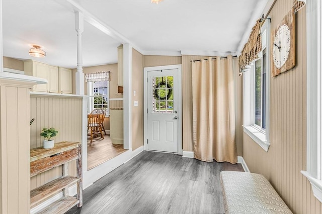 foyer entrance with wood finished floors and baseboards