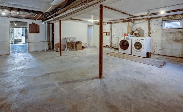 below grade area featuring washing machine and clothes dryer