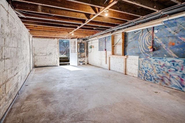 unfinished basement featuring water heater