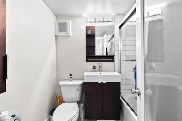 bathroom featuring visible vents, vanity, toilet, and enclosed tub / shower combo