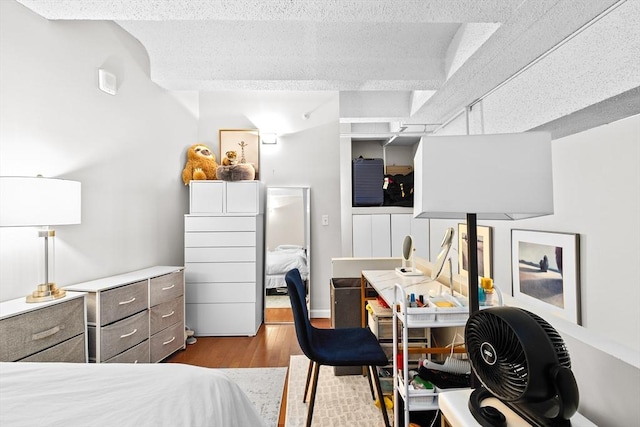 bedroom featuring a textured ceiling and wood finished floors