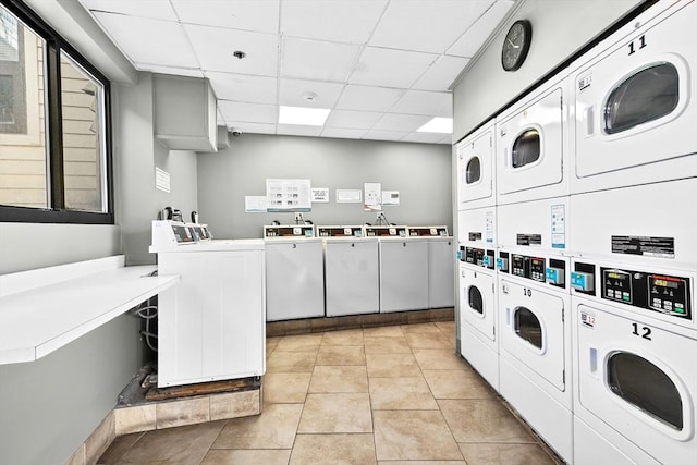 common laundry area with washer and clothes dryer, stacked washer / dryer, and light tile patterned flooring