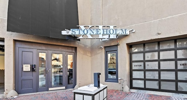 property entrance with stucco siding