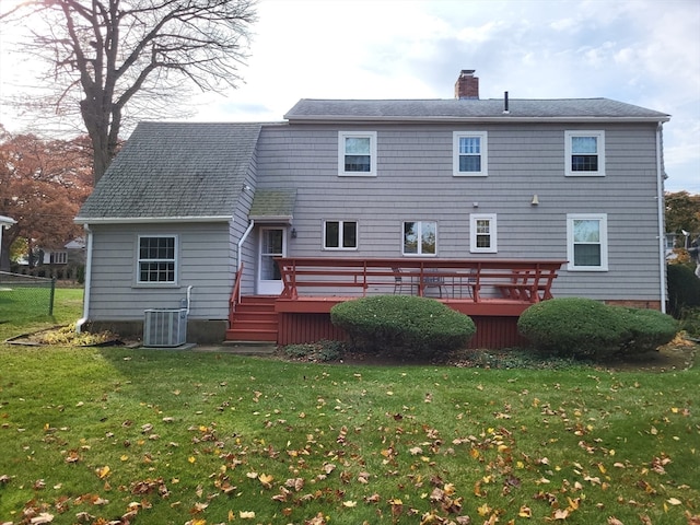 back of house with a deck, central AC, and a yard