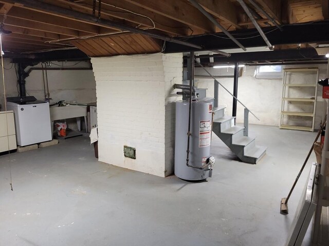basement featuring gas water heater and separate washer and dryer