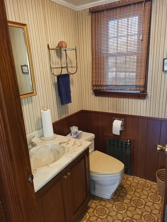 bathroom featuring toilet, radiator, vanity, and crown molding