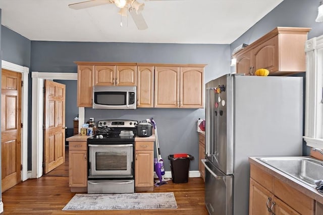 kitchen with ceiling fan, appliances with stainless steel finishes, dark wood finished floors, light countertops, and light brown cabinets