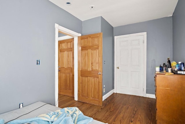 bedroom featuring baseboards and wood finished floors