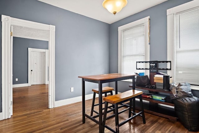 office featuring baseboards and wood finished floors