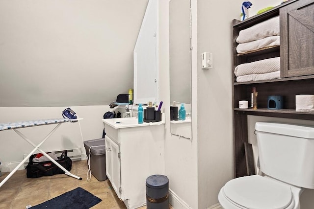 bathroom with toilet, baseboards, and vanity