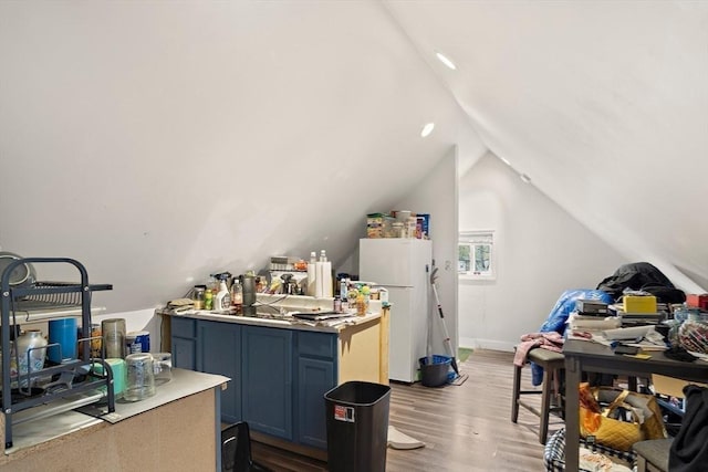 interior space with vaulted ceiling and wood finished floors