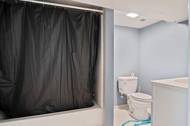bathroom featuring vanity, tile patterned flooring, shower / bath combo, and toilet
