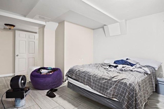 bedroom featuring visible vents and wood finish floors