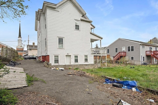 back of house with fence and stairs