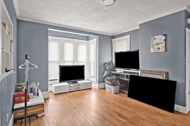 interior space with crown molding, baseboards, hardwood / wood-style flooring, and a textured ceiling