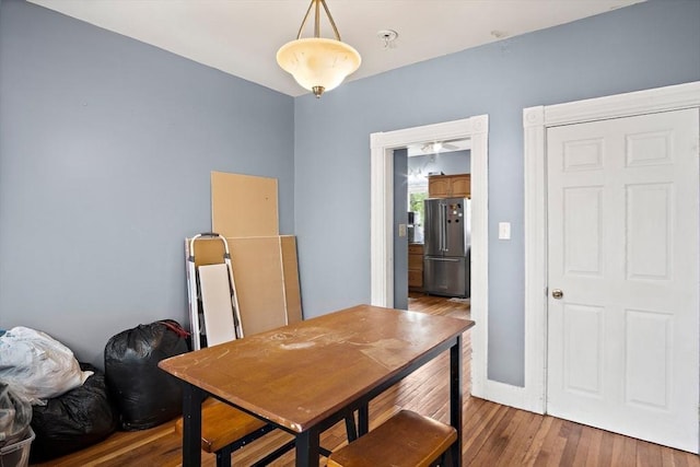 dining area featuring baseboards and wood finished floors