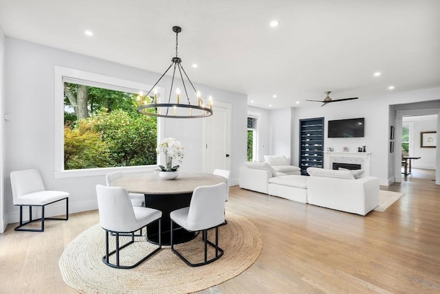 dining space with plenty of natural light, light wood-style floors, recessed lighting, and baseboards