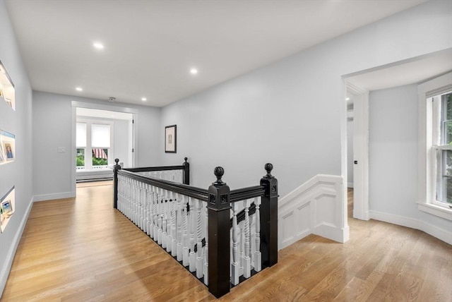 hall featuring recessed lighting, an upstairs landing, baseboards, and light wood finished floors