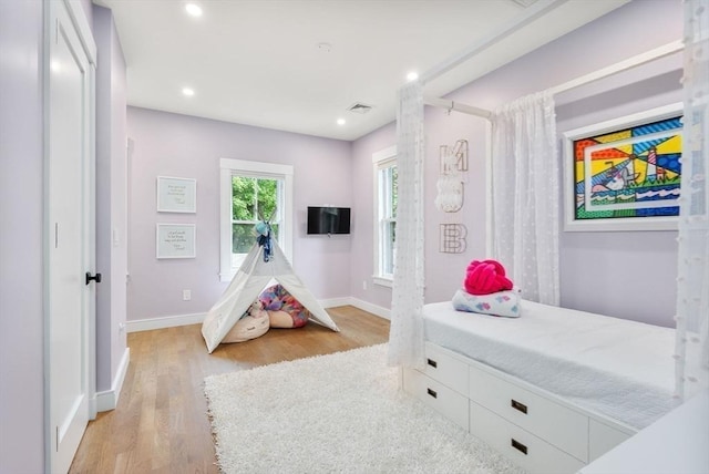 bedroom with recessed lighting, visible vents, light wood finished floors, and baseboards