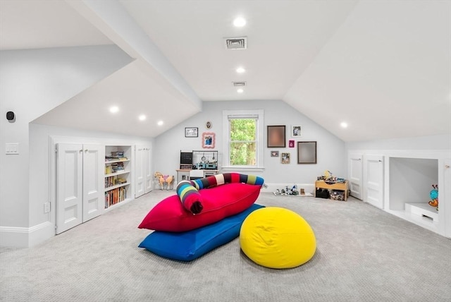 game room with carpet flooring, lofted ceiling, built in shelves, and visible vents