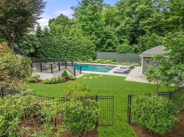 view of pool featuring a patio area, a lawn, a fenced backyard, and a fenced in pool