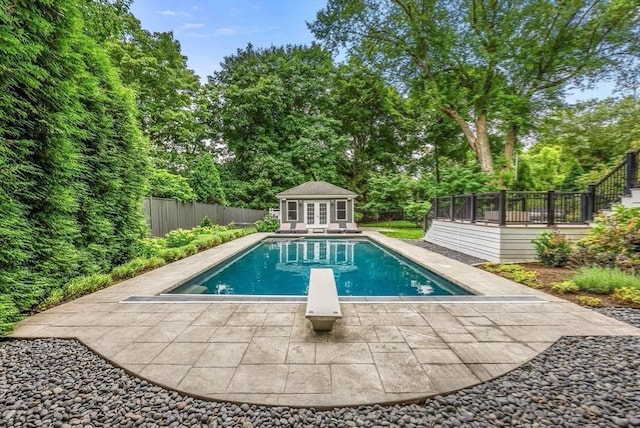 view of swimming pool with an outbuilding, a patio, a fenced backyard, an exterior structure, and a fenced in pool