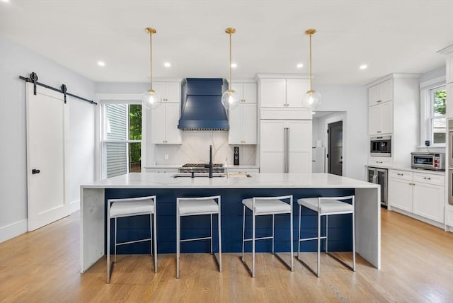 kitchen featuring beverage cooler, white cabinetry, paneled fridge, and premium range hood