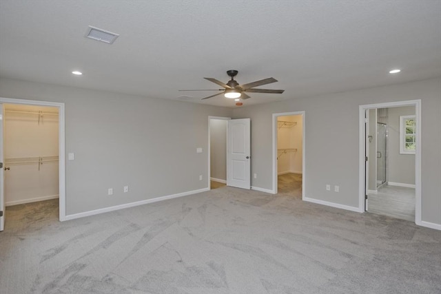 unfurnished bedroom featuring recessed lighting, a closet, visible vents, a spacious closet, and baseboards