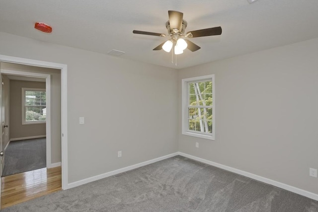 empty room with carpet and baseboards