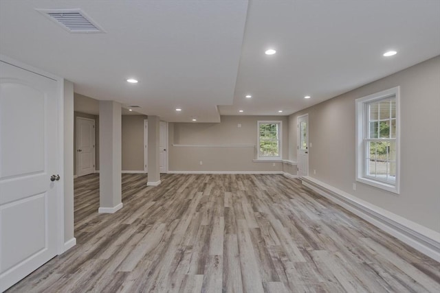 basement with light wood-type flooring, baseboards, visible vents, and recessed lighting