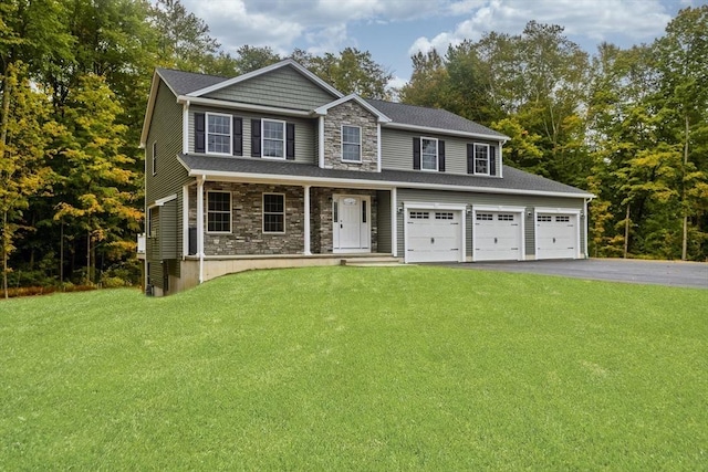 view of front of house featuring aphalt driveway, stone siding, an attached garage, and a front lawn