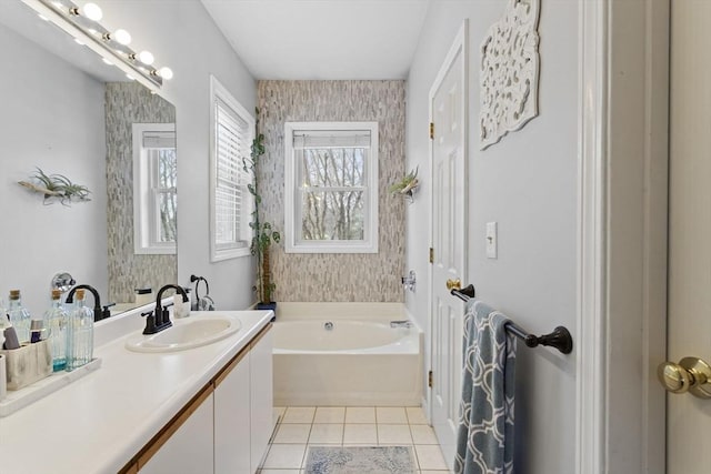 full bath with vanity, a bath, and tile patterned floors