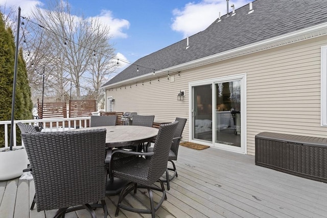 wooden terrace with outdoor dining space