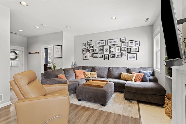 living room featuring light wood-style flooring and recessed lighting