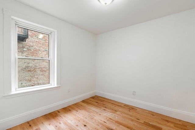 empty room with wood finished floors and baseboards