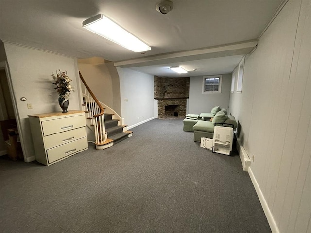 interior space featuring stairway, a large fireplace, baseboards, and dark carpet