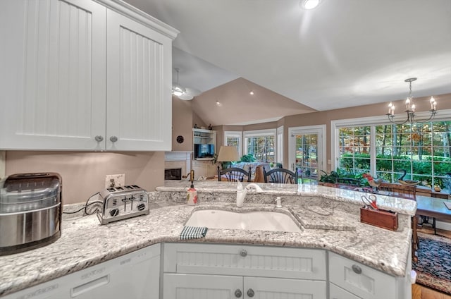 kitchen featuring an inviting chandelier, dishwasher, white cabinets, and sink