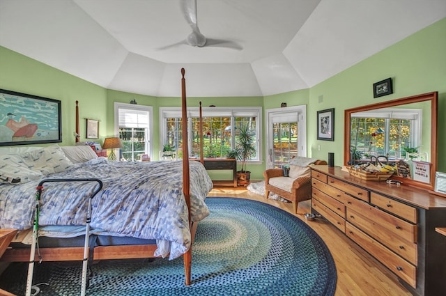 bedroom with ceiling fan, lofted ceiling, and light hardwood / wood-style floors