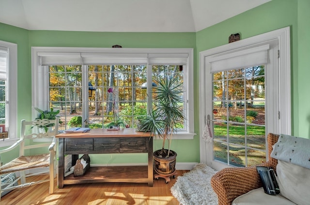 sunroom / solarium featuring lofted ceiling