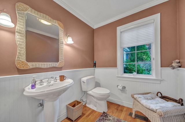 bathroom featuring toilet, crown molding, and wood-type flooring