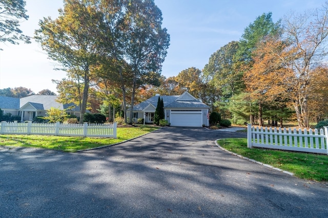 view of front facade with a front yard and a garage