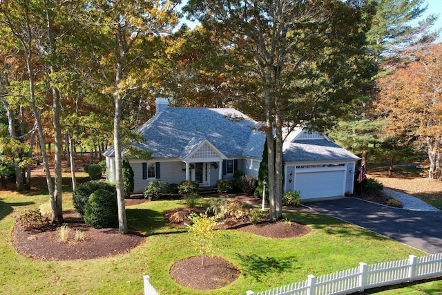 view of front of house featuring a front lawn and a garage