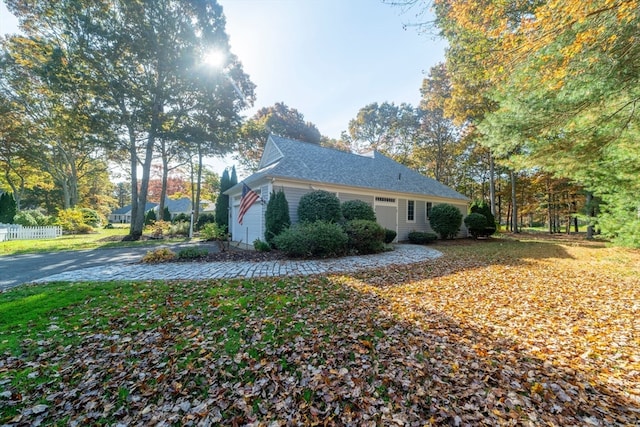 view of side of home featuring a garage